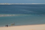 Skipper chatting to National Parks officials on Bazaruto Island. Yes, the little boat you see there is our dhow !