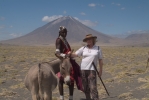 Pat with our Maasai guide, Ntakawa, and the active volcano in the far background